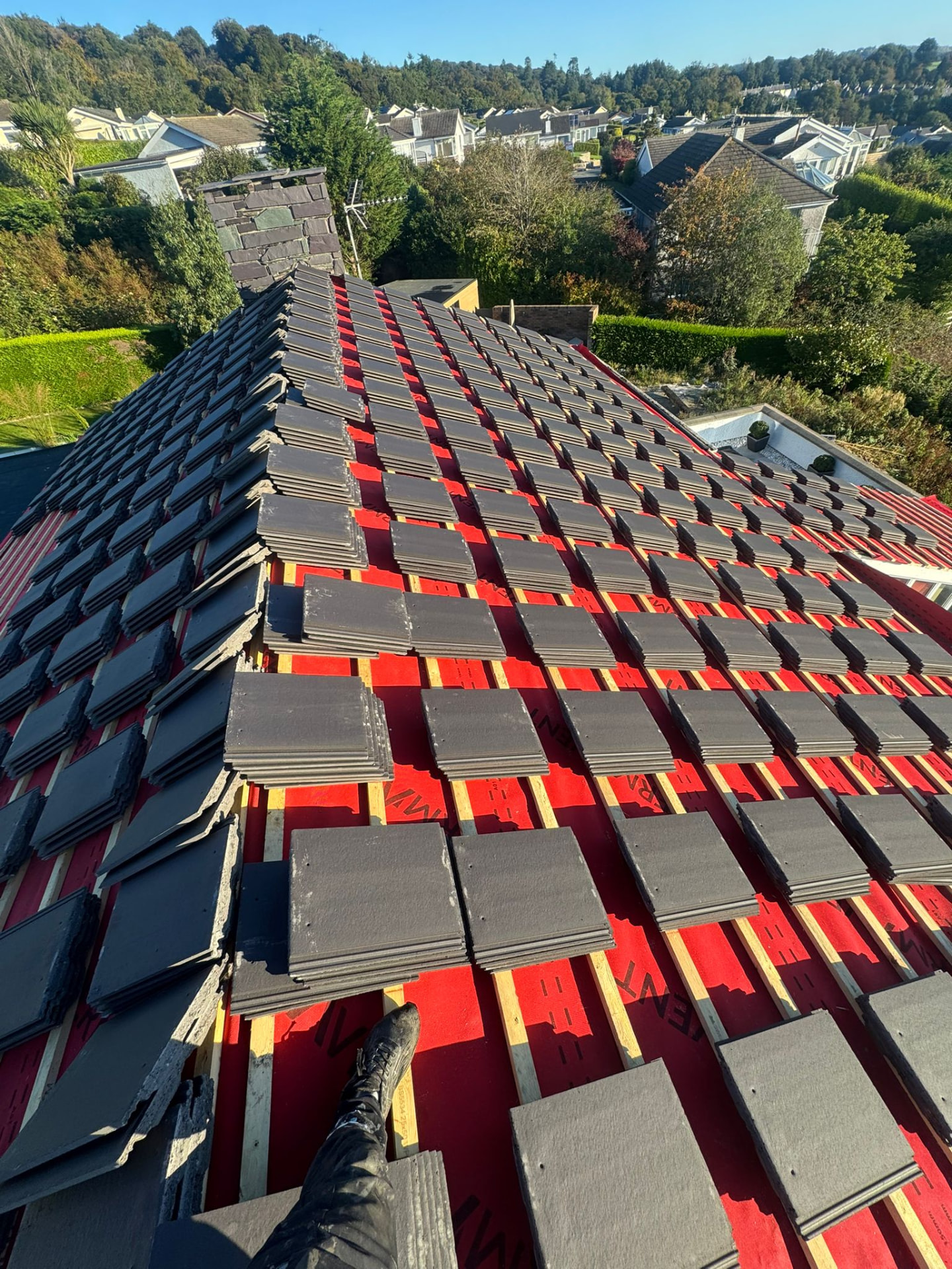 Full roof replacement in progress with new breathable membrane and stacked tiles