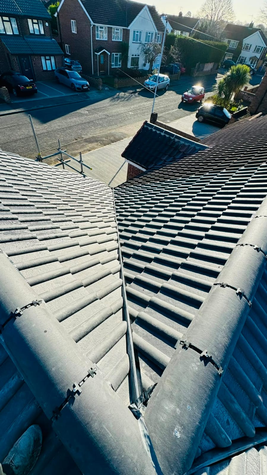 New tiled roof and valley on a semi-detached house viewed from the ridge