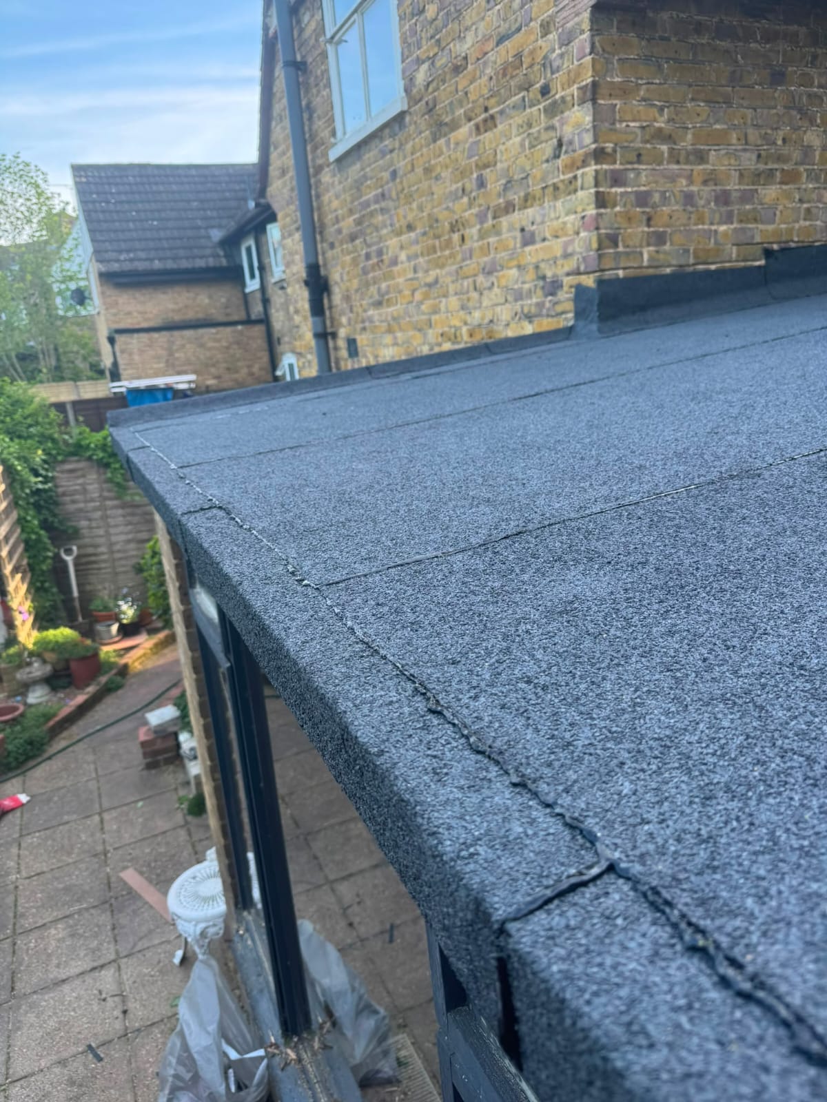 Failed flat roof covering before replacement in North Wales