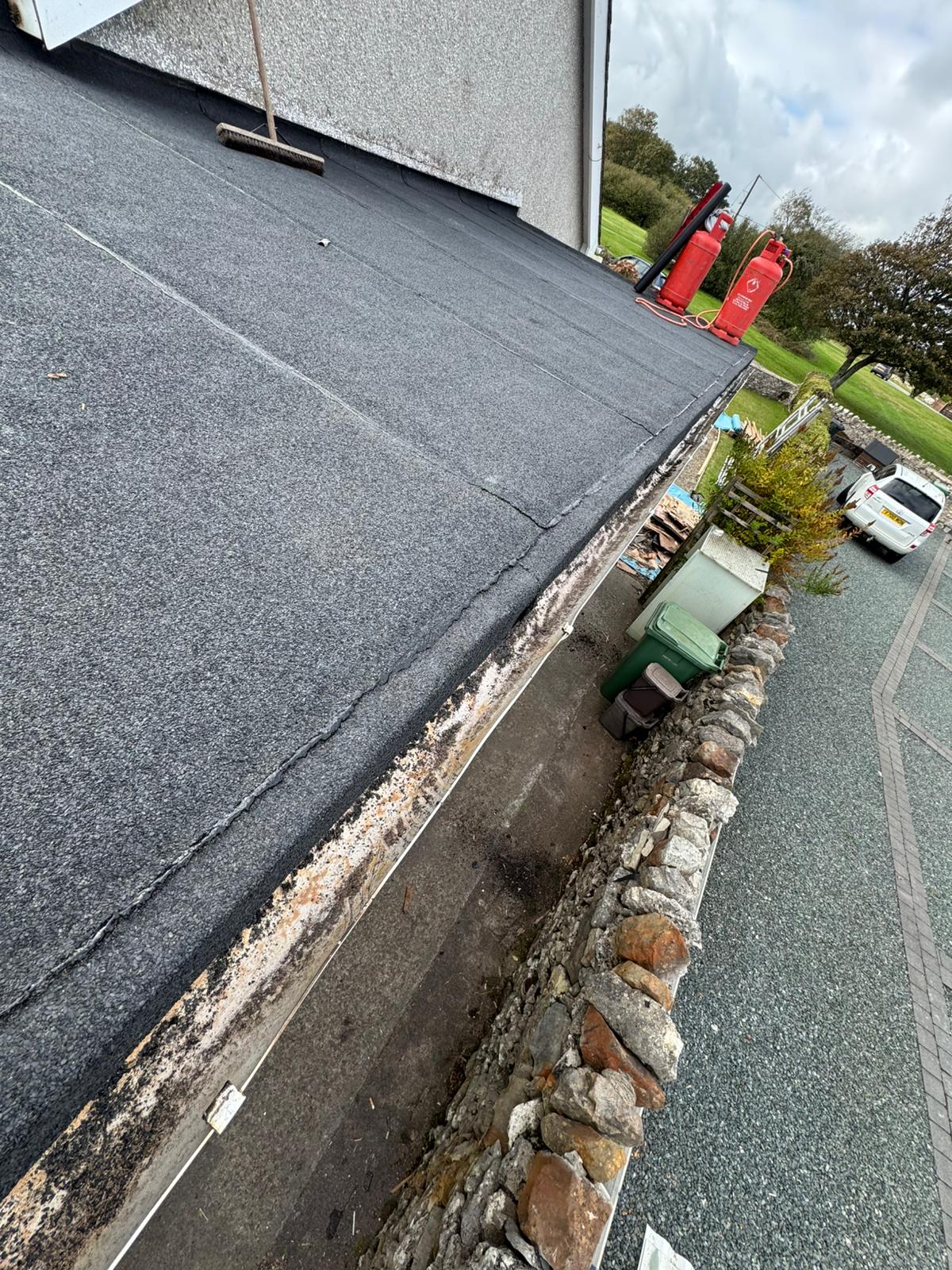 Failed flat roof covering before replacement in North Wales