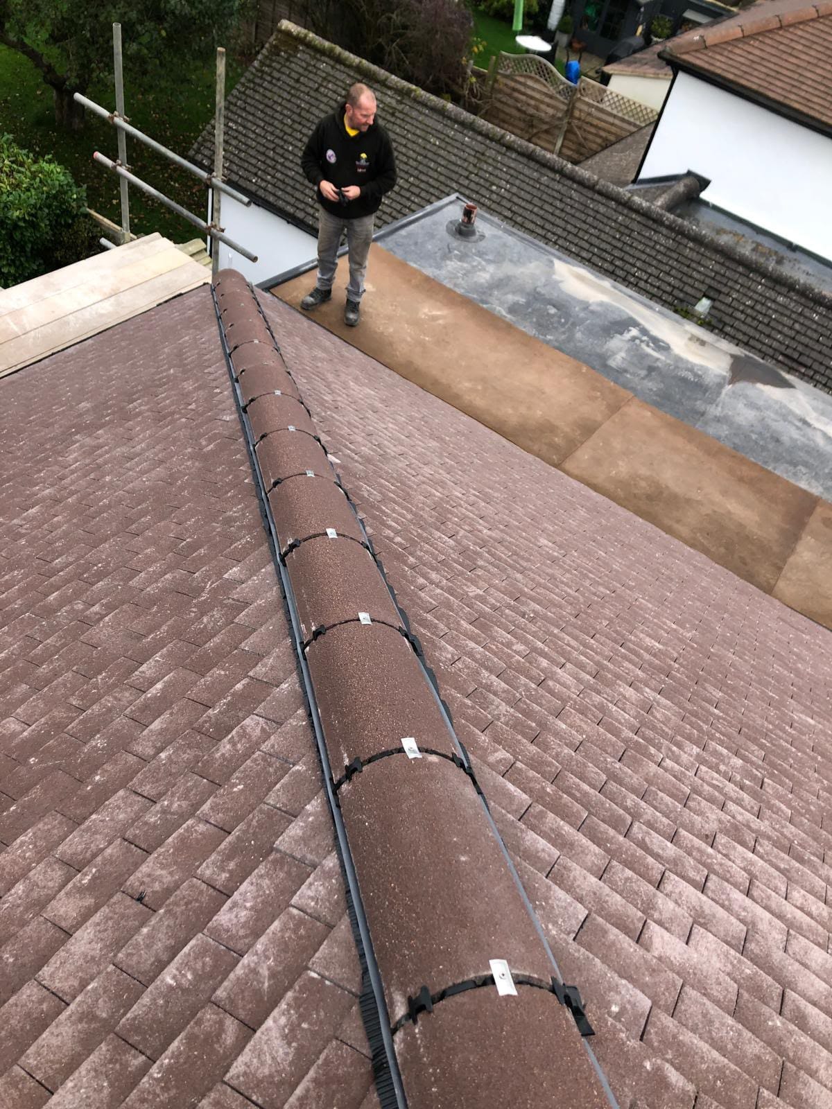 Completed tiled roof with new ridge tiles and guttering in North Wales