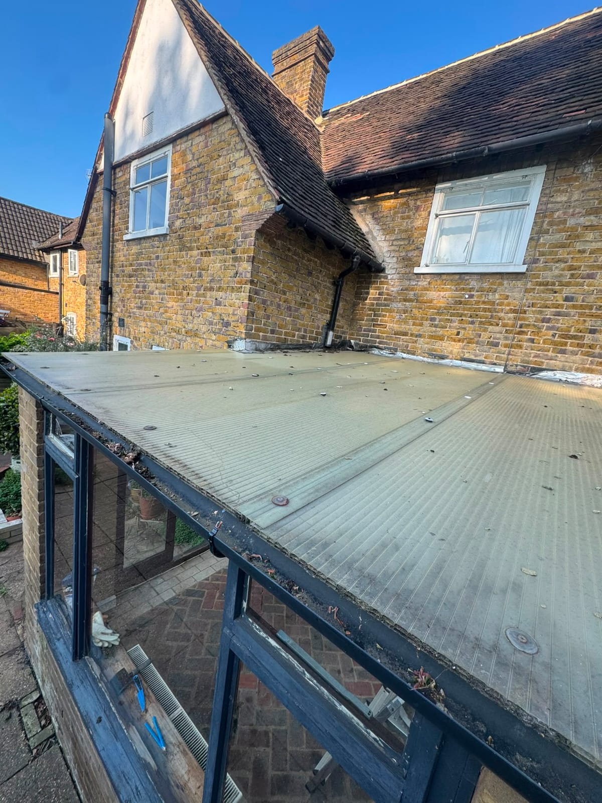 Failed flat roof covering before replacement in North Wales