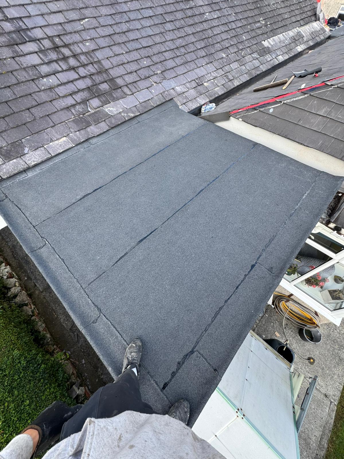 Completed flat roof replacement with clean seams and new edge trims