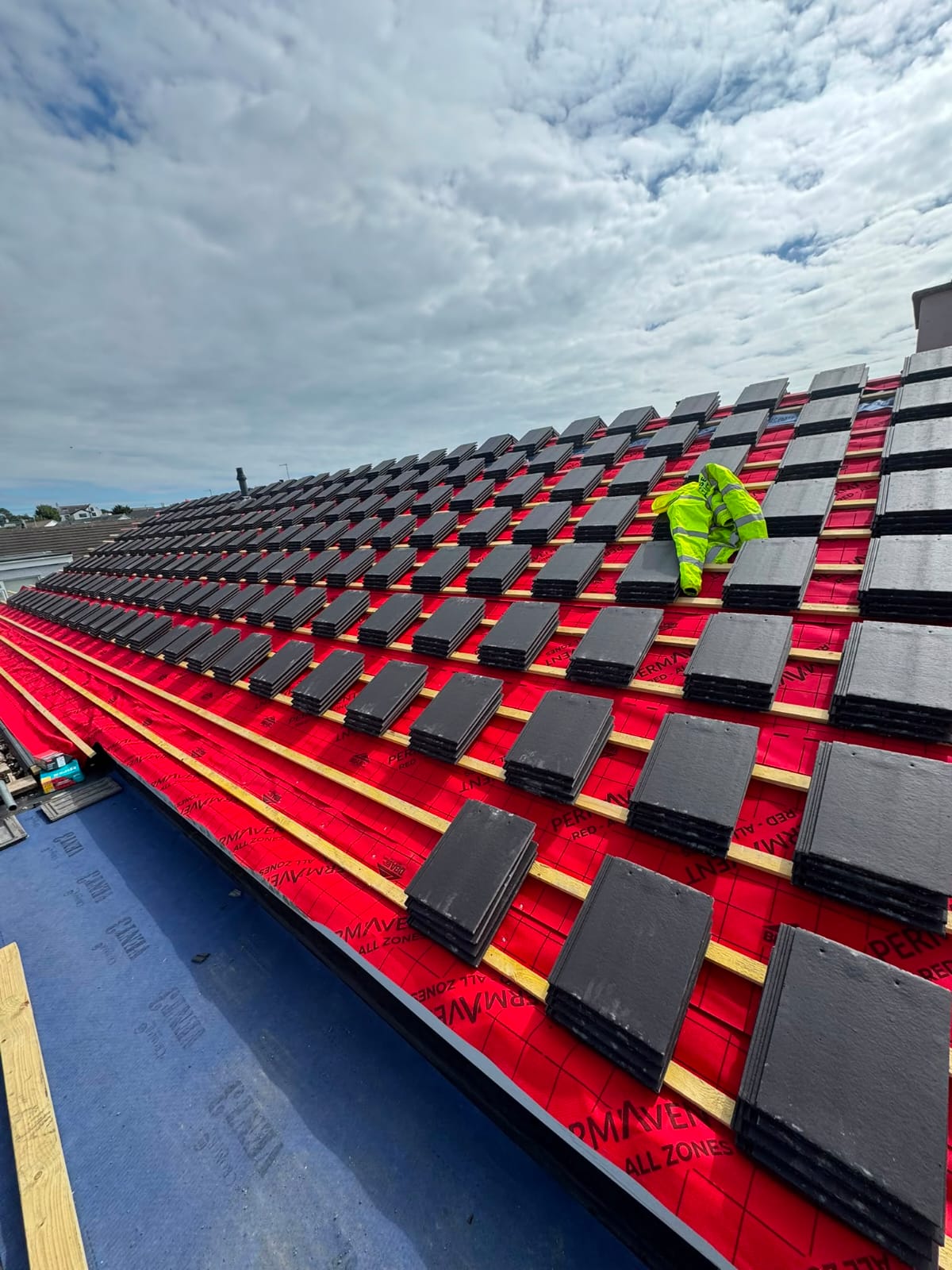 Full roof replacement in progress with new breathable membrane and stacked tiles