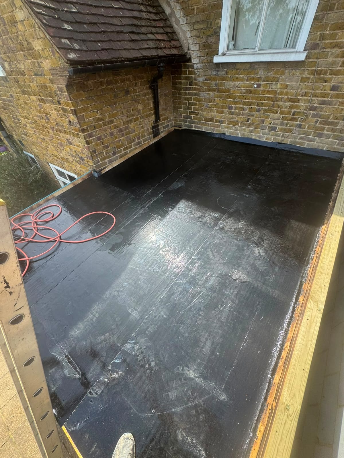 Completed flat roof replacement with clean seams and new edge trims