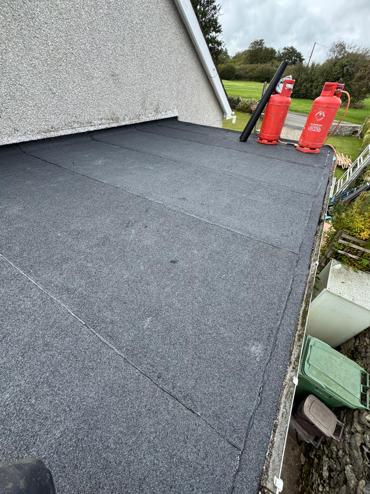 Repaired and resealed felt flat roof on a domestic extension in North Wales