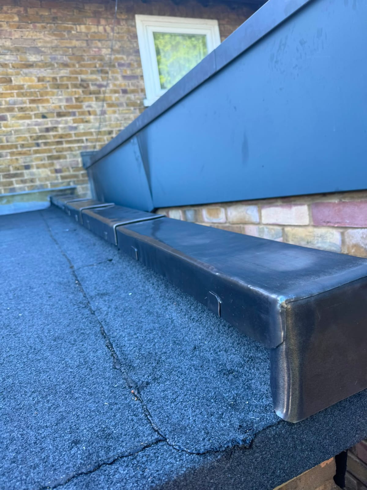 Finished lead flashing and lead valley work on a slate roof