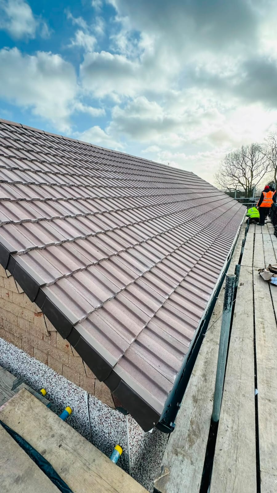 Completed tiled roof with new ridge tiles and guttering in North Wales