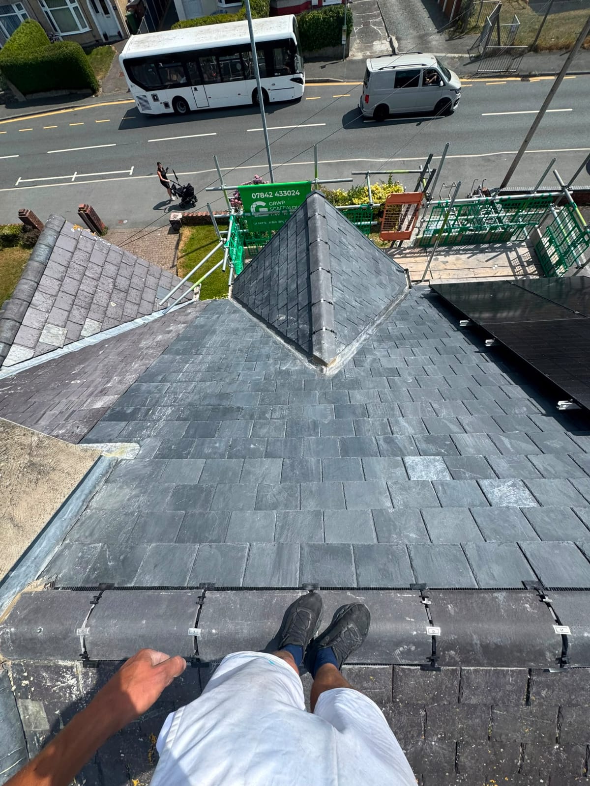 Completed natural slate roof with neat ridge tiles and lead detailing